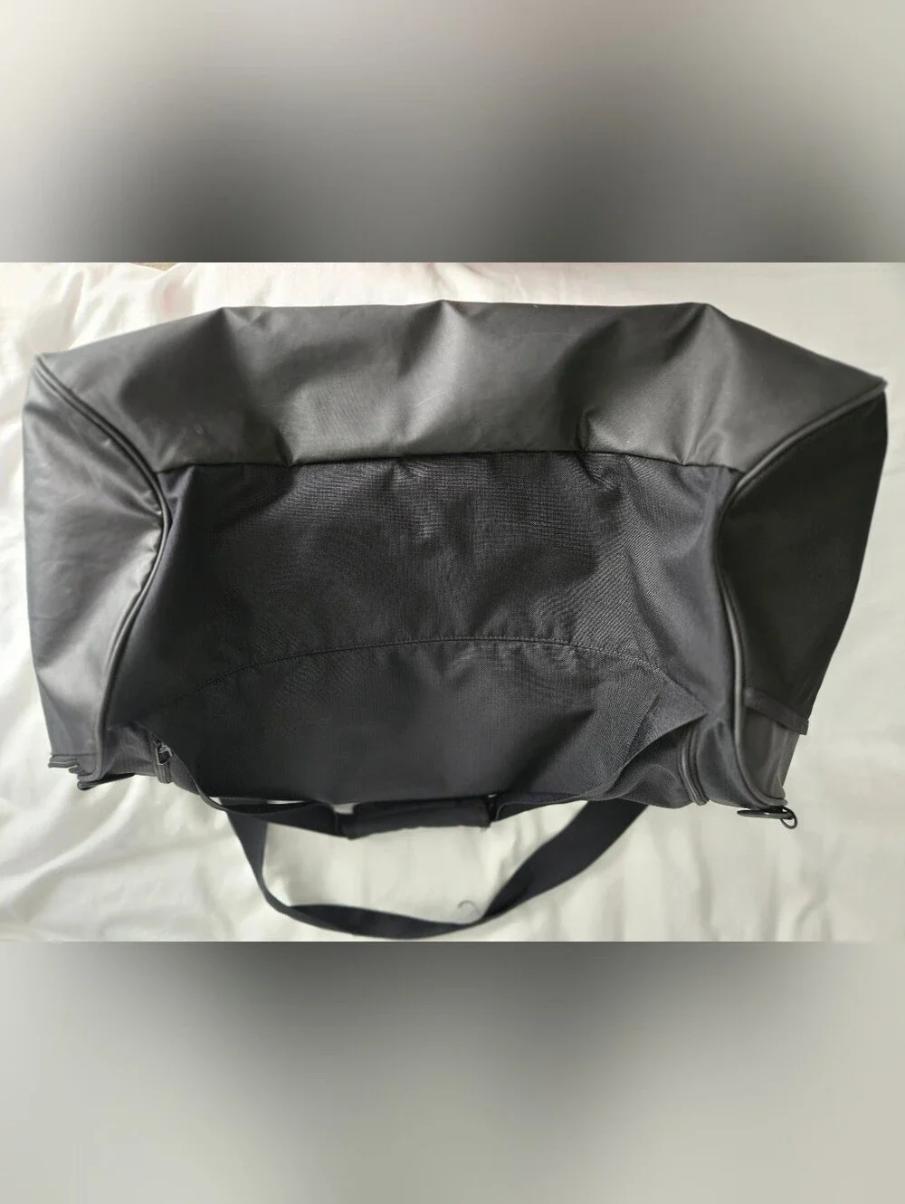 Nike Black Duffel Bag with White Swoosh and Bottom Zipper Pocket.